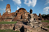 Ayutthaya, Thailand. Wat Mahathat, a Buddha statue of the gallery enclosing the collapsed central prang.